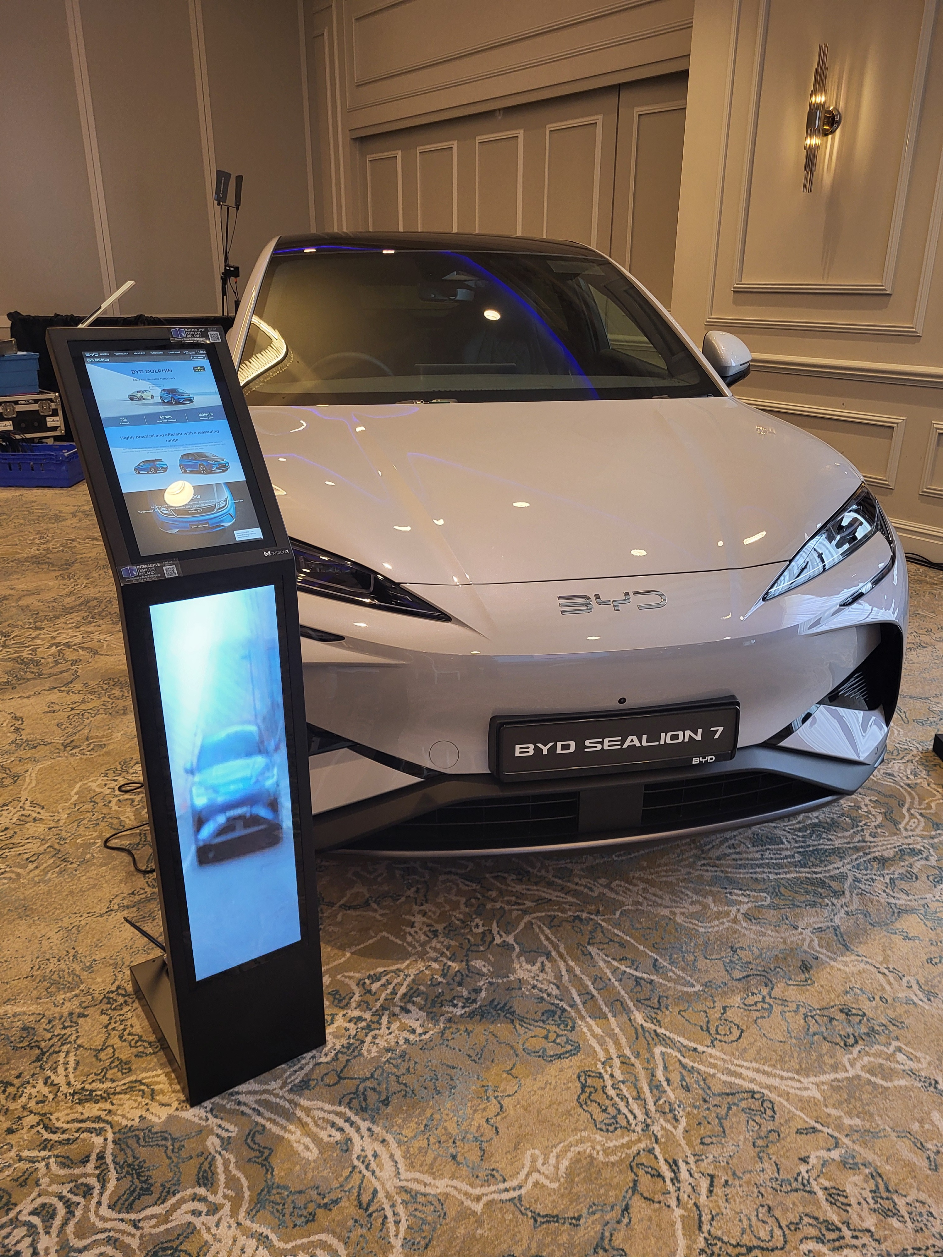 Showroom Display beside a BYD electric car